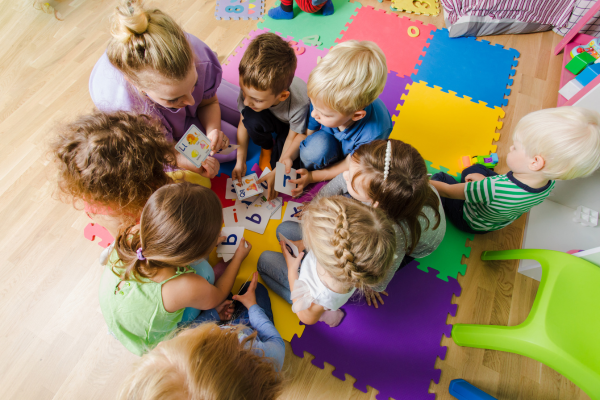 Early Years Educator with children in a circle