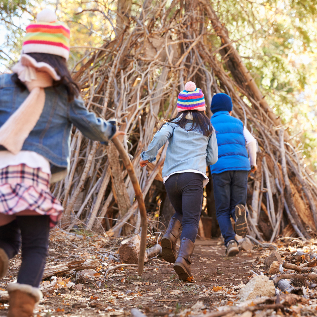 Children playing outside in forest