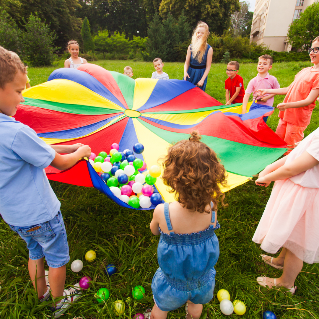 Children playing outside with parachute