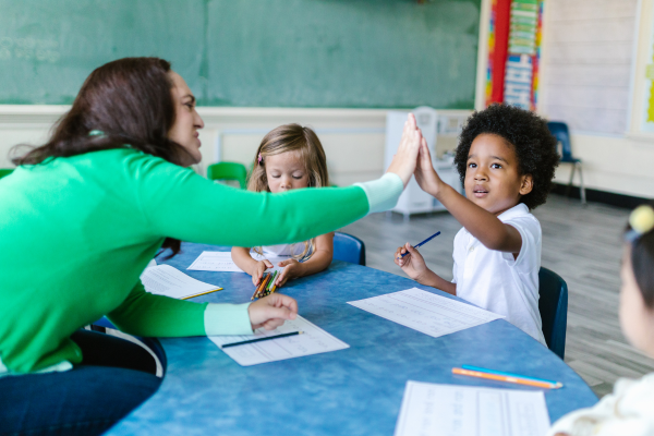 Student giving a Teaching Assistant a high-five