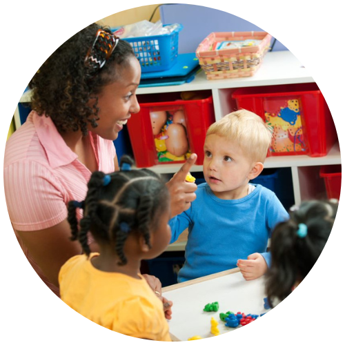 Nursery teacher playing with children